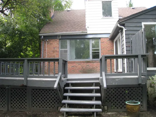 Riverview backyard with mature trees and views toward the river setting