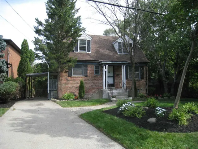 Front exterior of Riverview, a modern home on a tree-lined lot